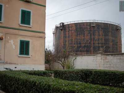 ...in fondo alla quale campeggia la massiccia sagoma di uno dei tre serbatoi di olio dell�industria